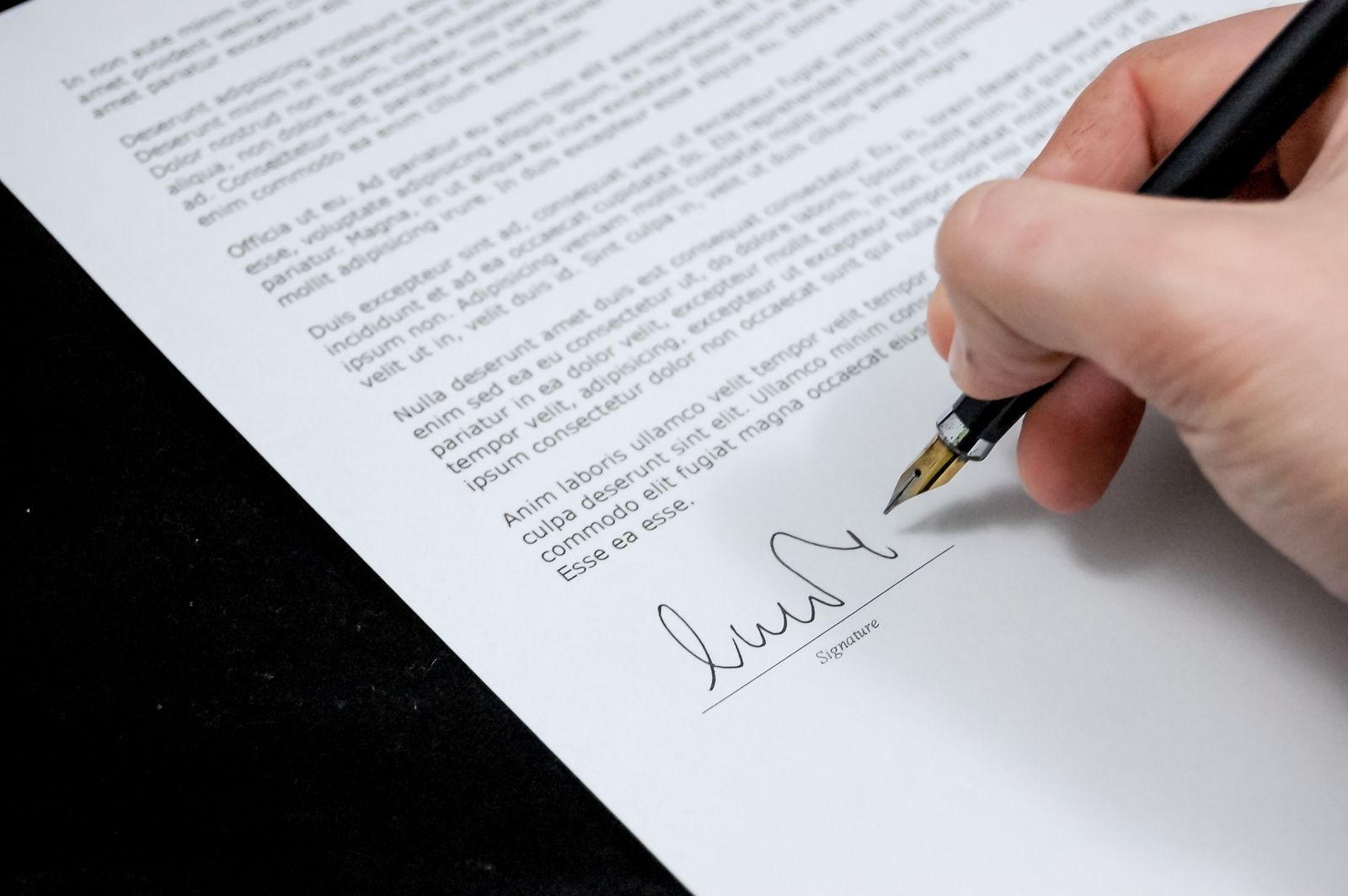 A notarial deed of incorporation being signed at a desk.