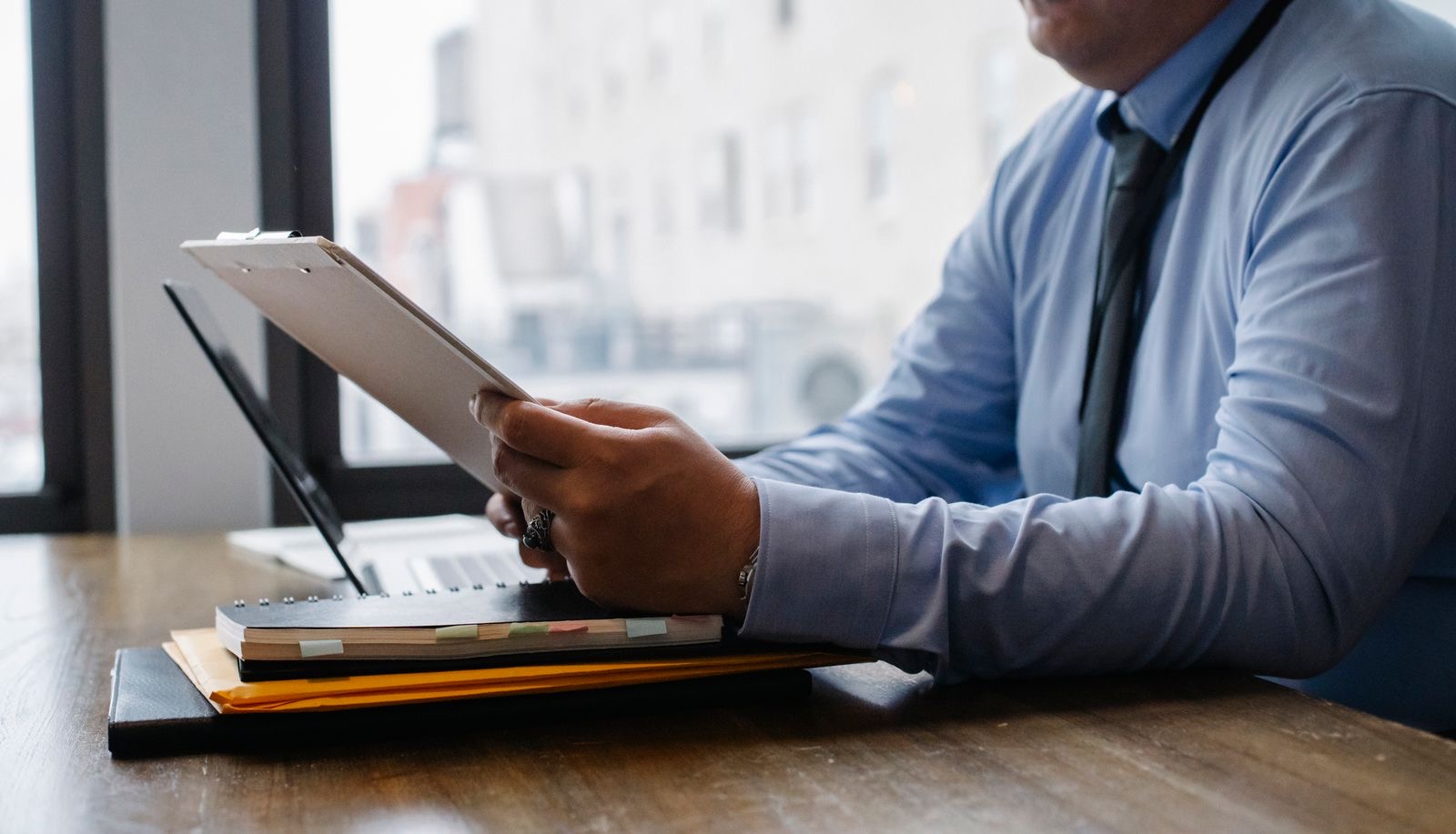 A founder abroad reviewing company formation documents beside a laptop.