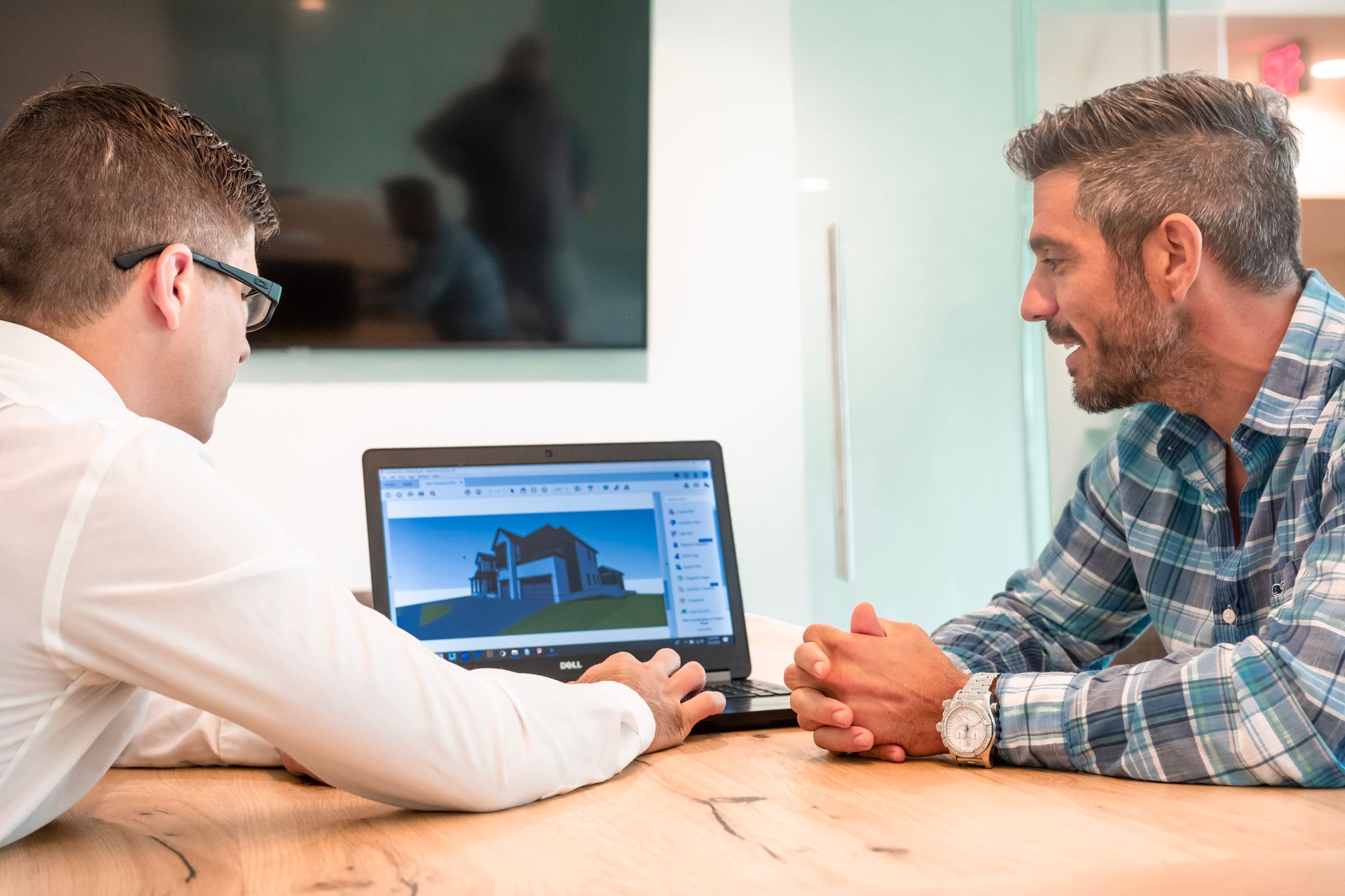 An international engineer working on a laptop in an Amsterdam office