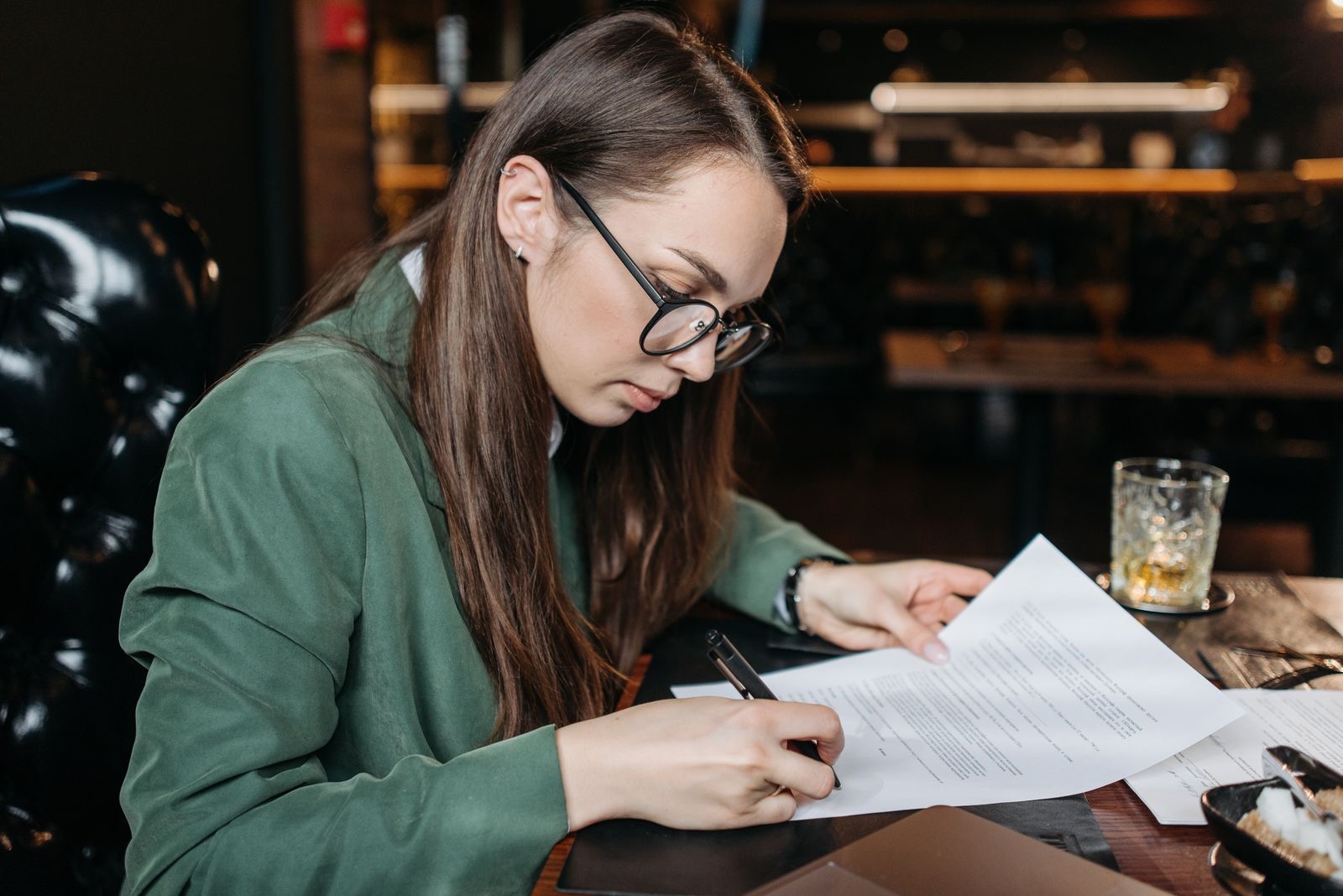 A pen signing a deed on a desk
