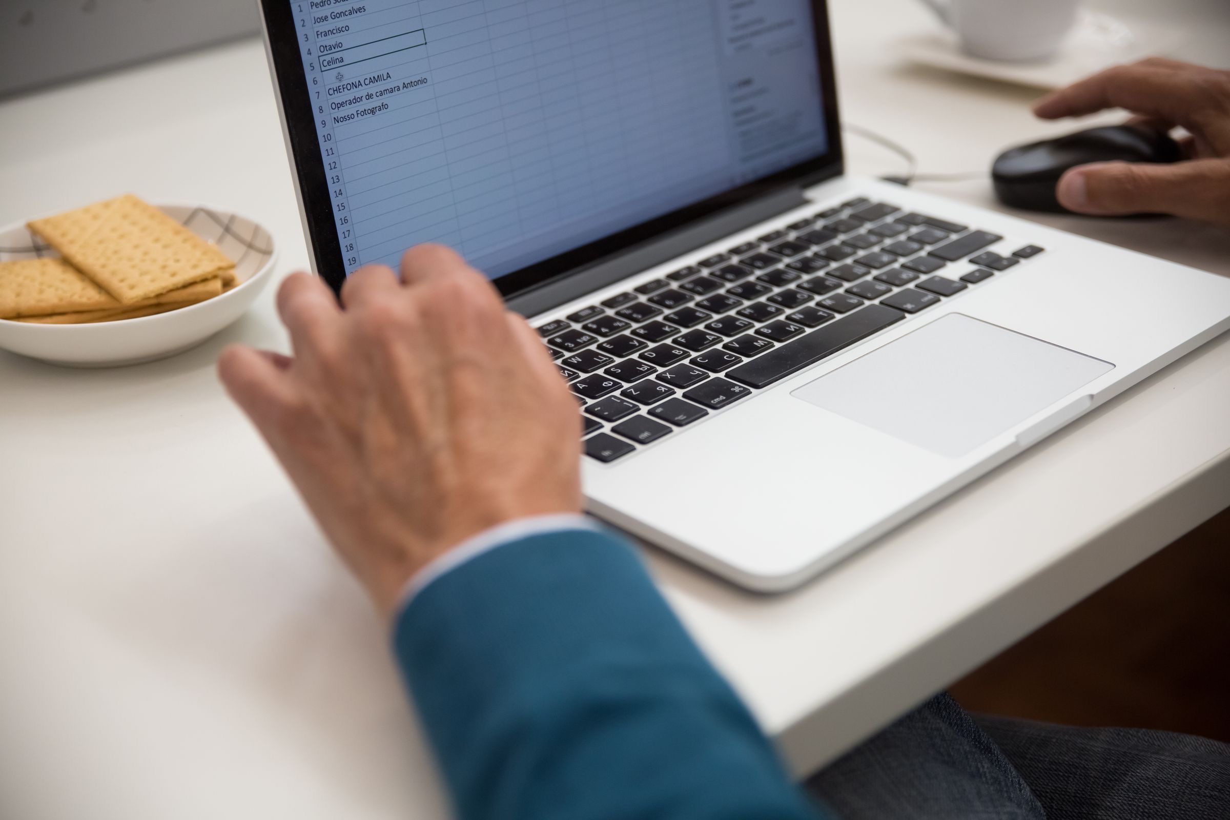 A company founder abroad reviewing a Dutch BV's figures on a laptop in the evening.