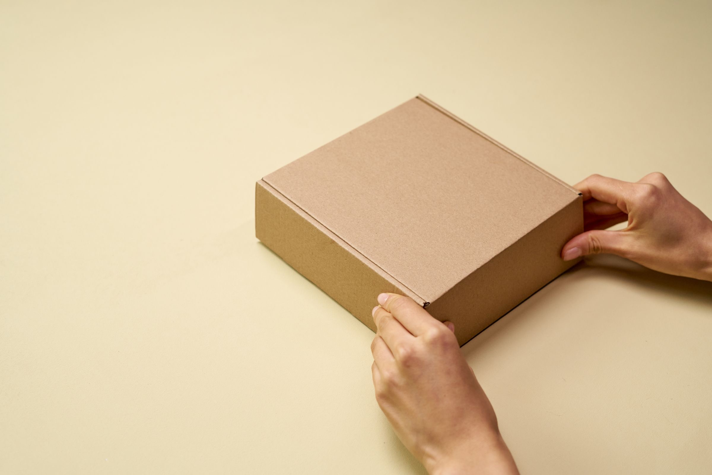 Unbranded product packaging and a sketched wordmark on a studio desk before a brand launch.