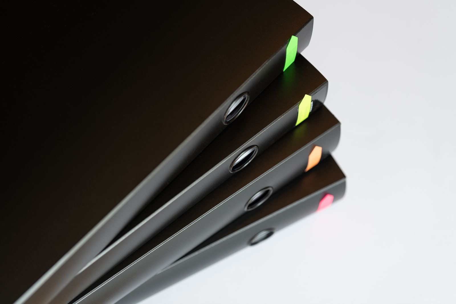 Ring binders with tabbed dividers beside a laptop, the documents of a trust office licence application file.