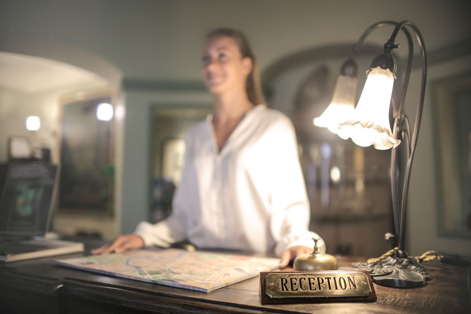 A hotel reception desk with a guest checking in